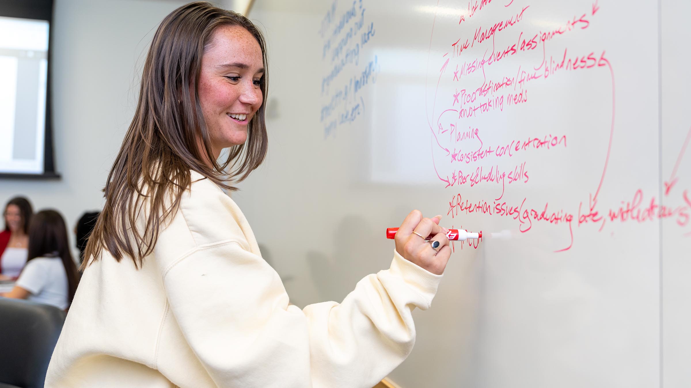 TU student writing on a whiteboard