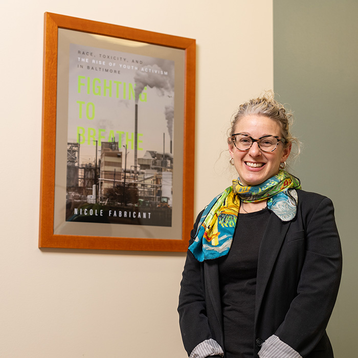 Nicole Fabricant standing in front of a book she wrote