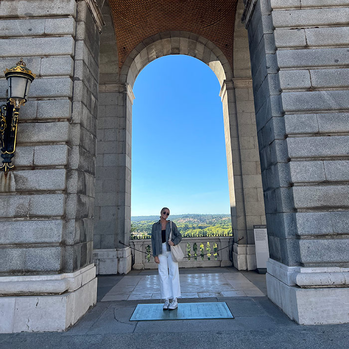 Person posing under arch