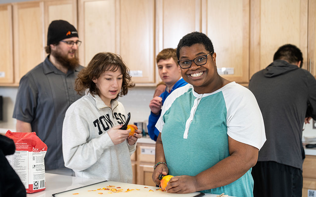 Two people cooking and smiling