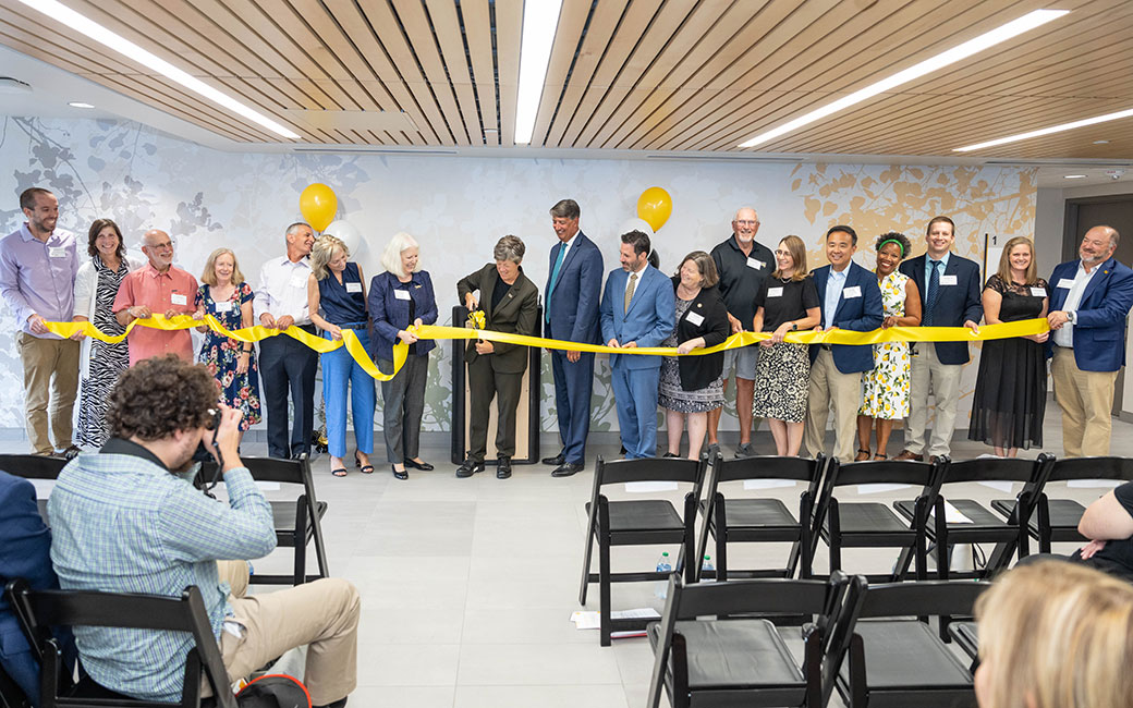 People gather to cut the ribbon. 