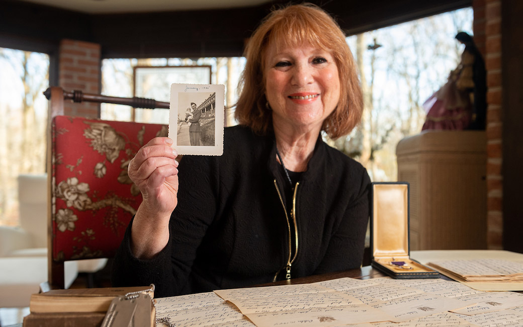 Woman holding black and white photo