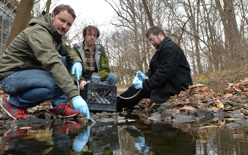 Joel Moore, center, with students conducting research