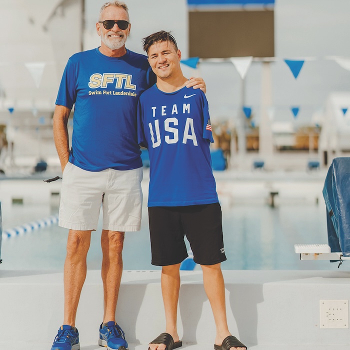 Marty Hendricks standing by the pool with Karimi