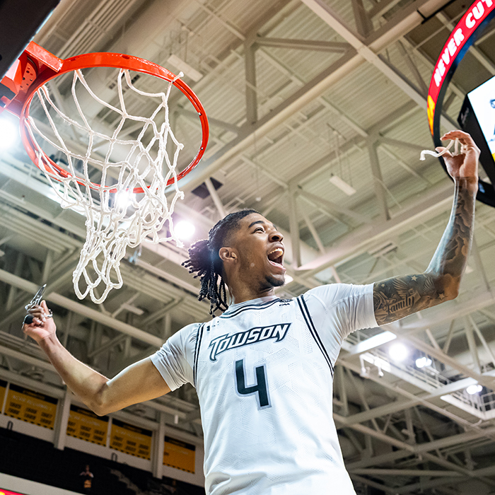 men's basketball cuts net after championship win