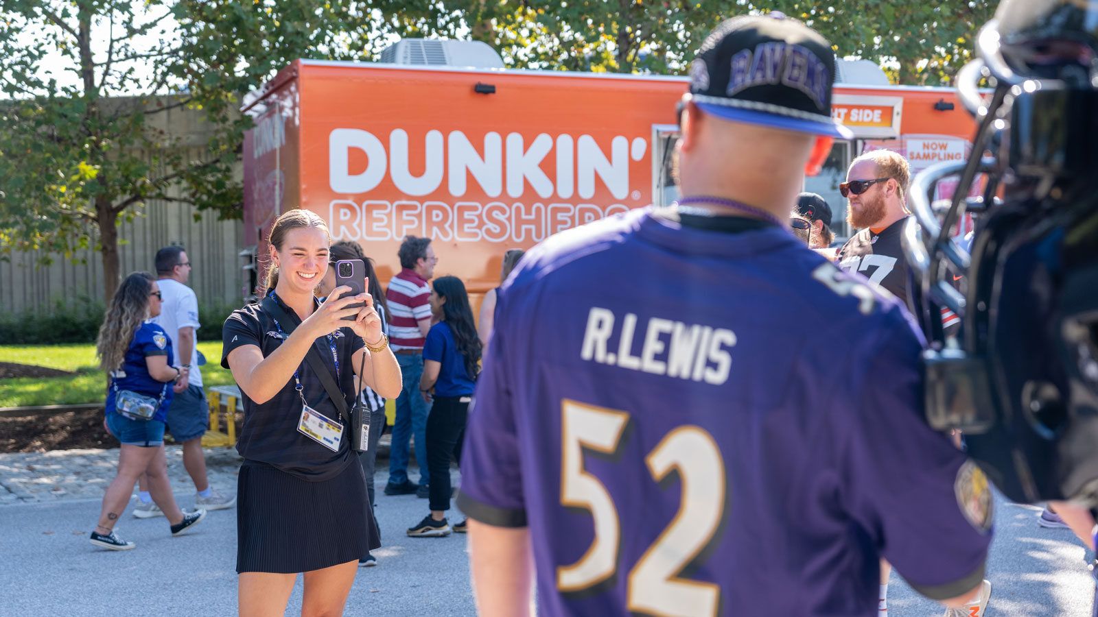 Sara ParksVold taking pictures of fans at RavensWalk before a Baltimore Ravens Game  