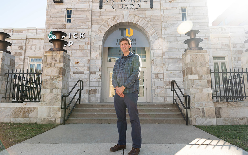Man stands in front of Armory building