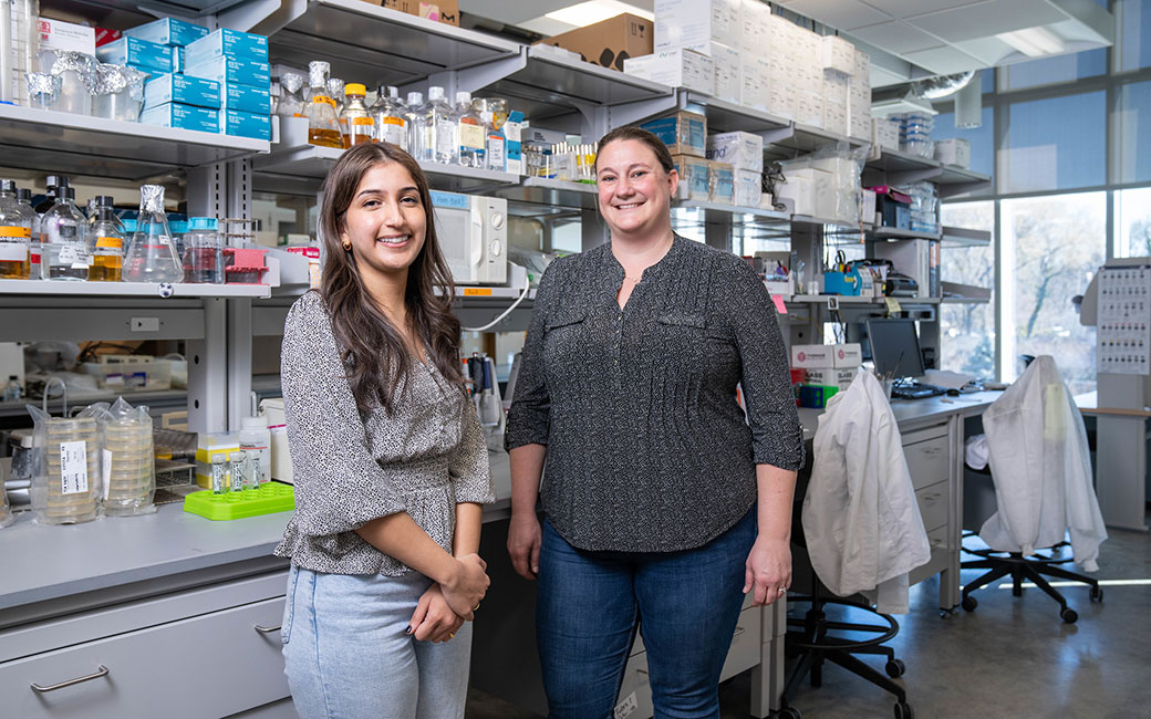 Two women pose in lab