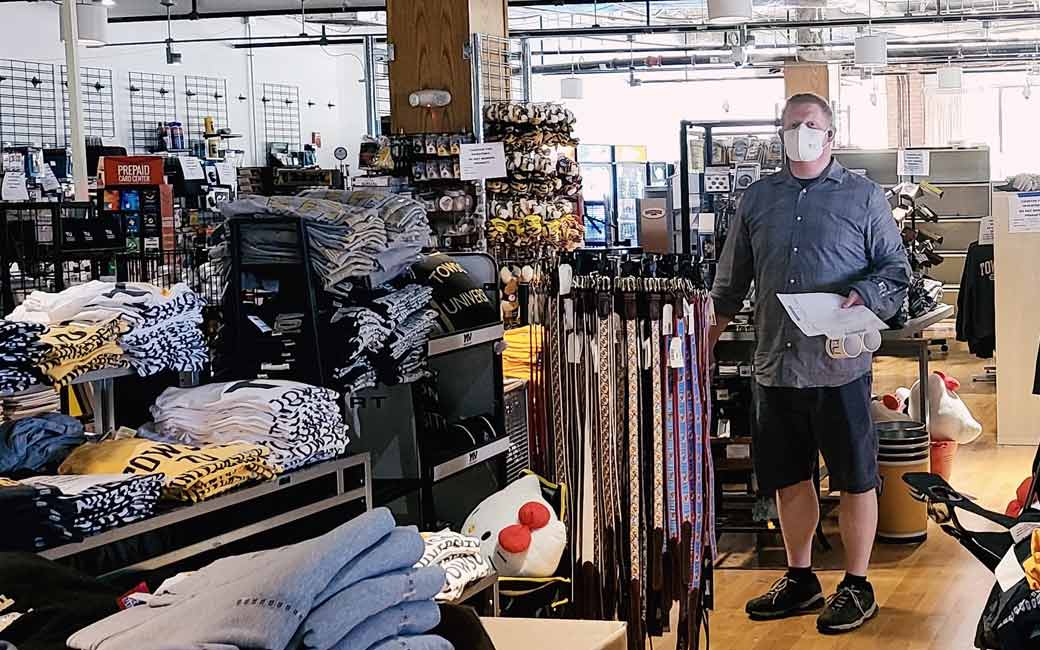 Ustore employee with face mask stocking