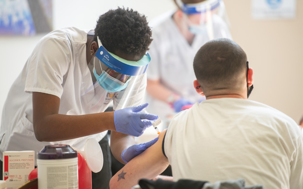 Nursing student Adwoa Mensah '21 administers a dose of vaccine