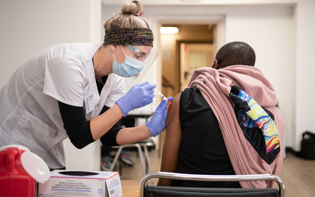 Nursing student Katie Lastova '21 administers a dose of the COVID-19 vaccine.