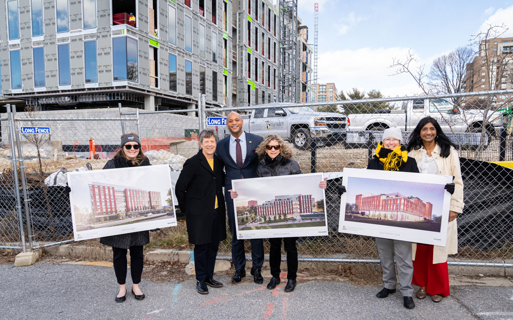 People pose at construction site