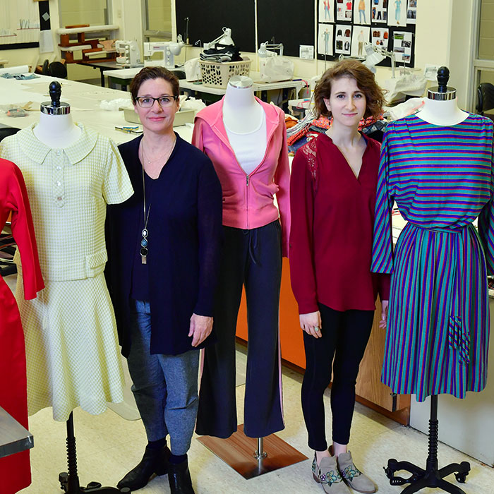 Two women posing with mannequins