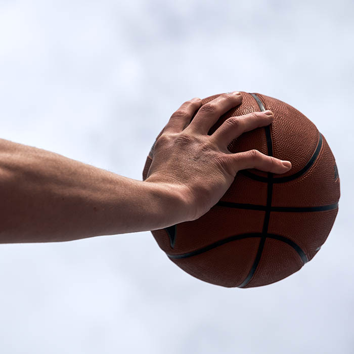 hands holding a basketball