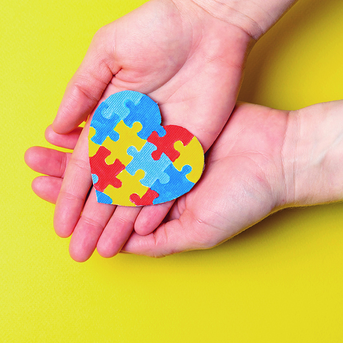 two hands holding a puzzle heart