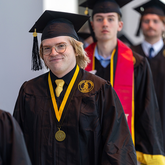 male graduate walking