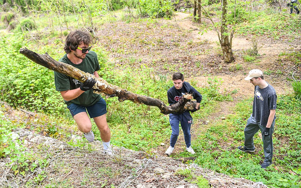 Students haul branches. 