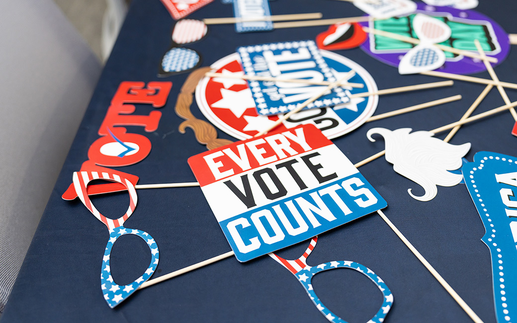 Election-themes photo booth props are displayed on a table.