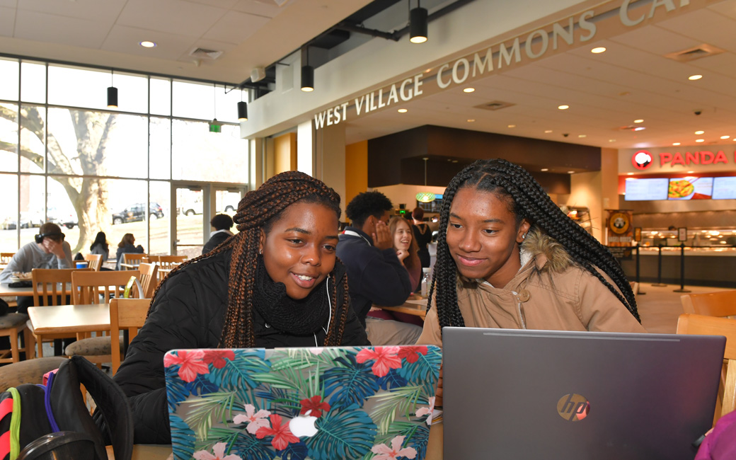 Two students working on laptops
