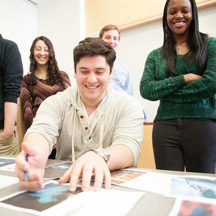 Students looking over papers on desk