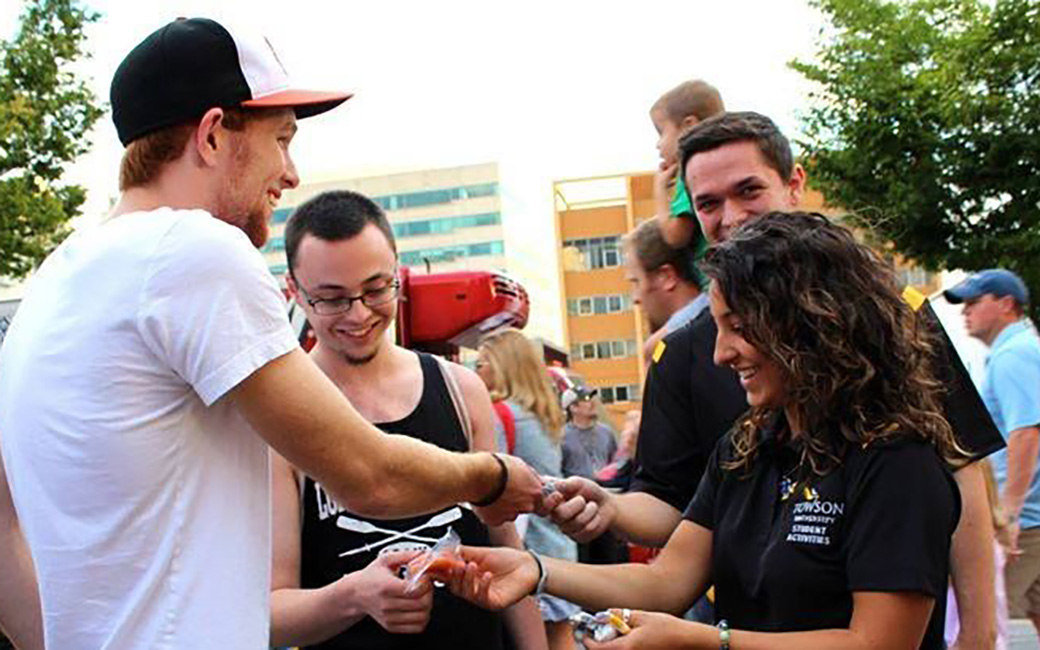 Student employees handing out flyers at an event